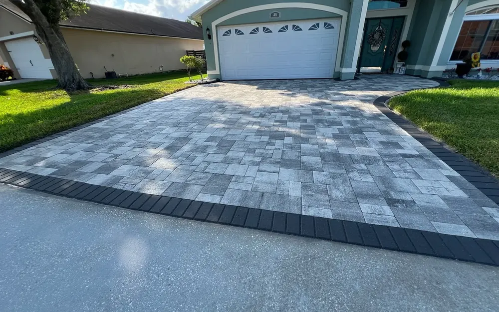 Sealed paver driveway with charcoal border in Oviedo, FL