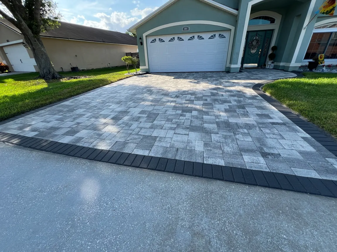 Sealed paver driveway with charcoal border in Oviedo, FL, cleaned and re-sanded before sealing